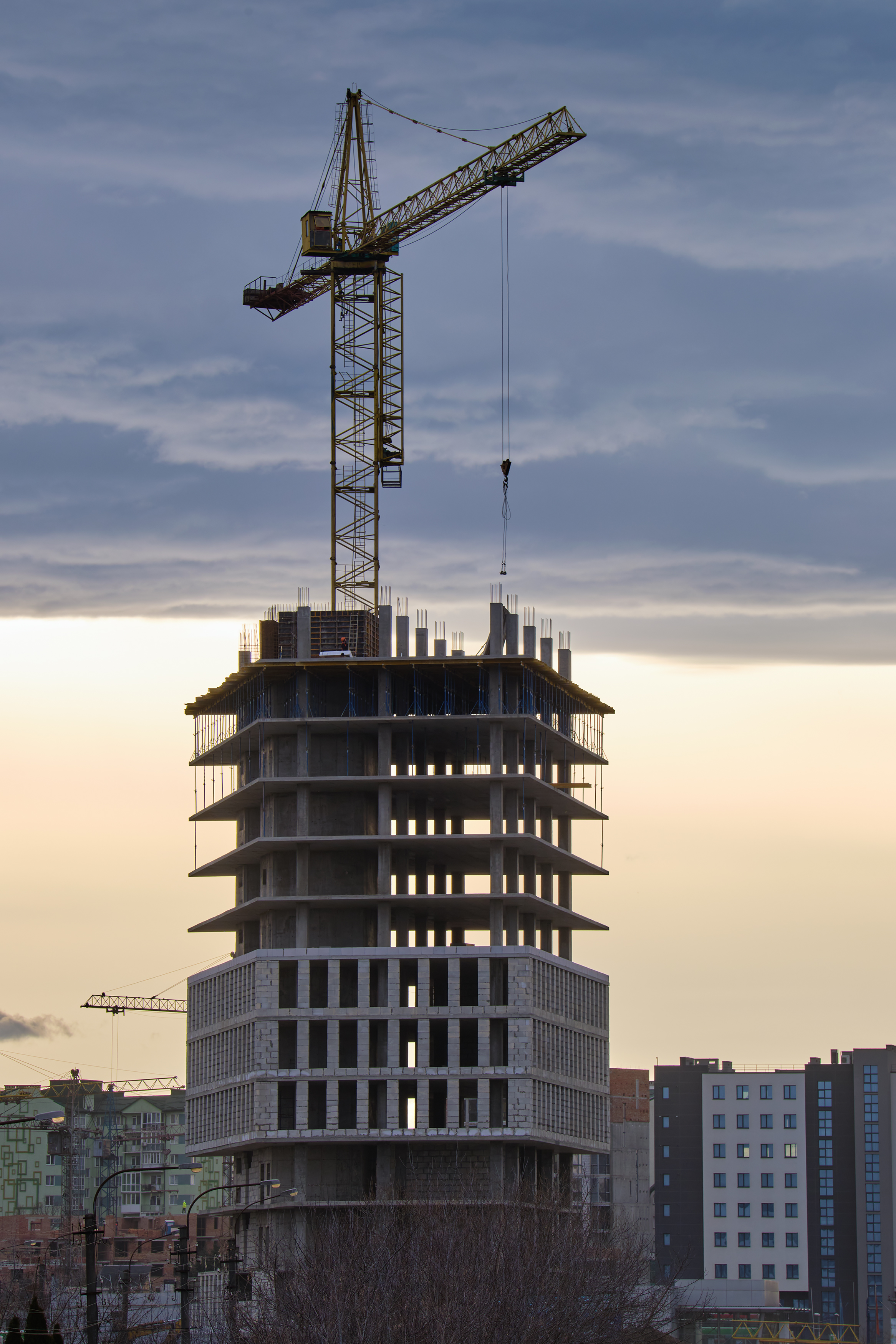 Tower cranes at high residential apartment buildings construction site. Real estate development